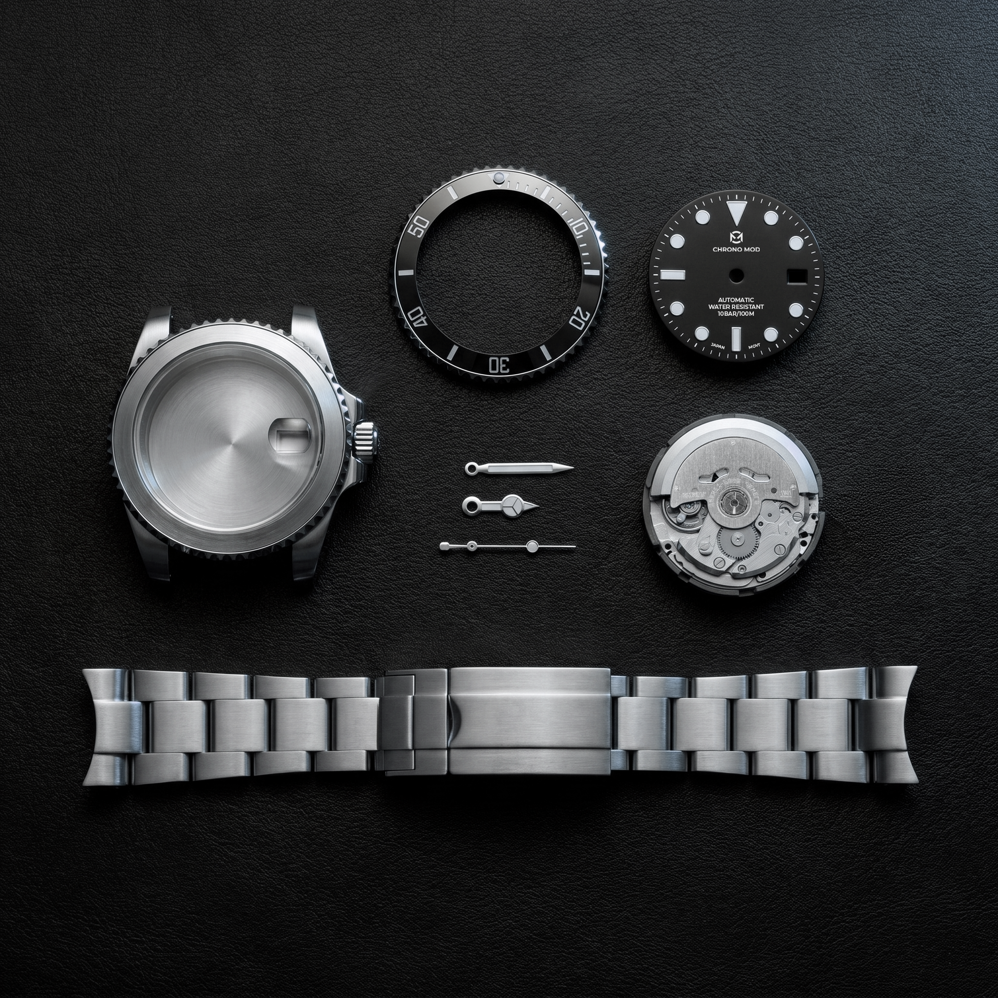 Watch components flat-lay on black leather — case, bezel, dial, hands, movement, oyster bracelet